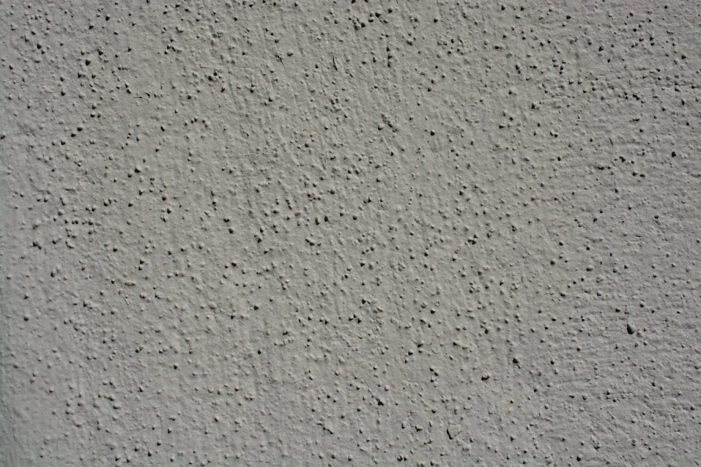 A close-up view showcasing the intricate texture of a gray stucco wall, perfect for backgrounds.