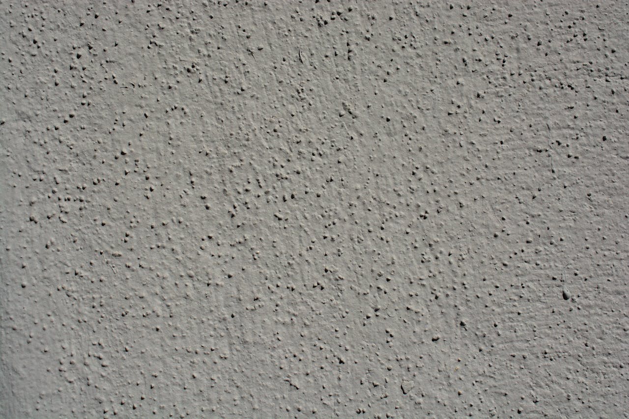 A close-up view showcasing the intricate texture of a gray stucco wall, perfect for backgrounds.